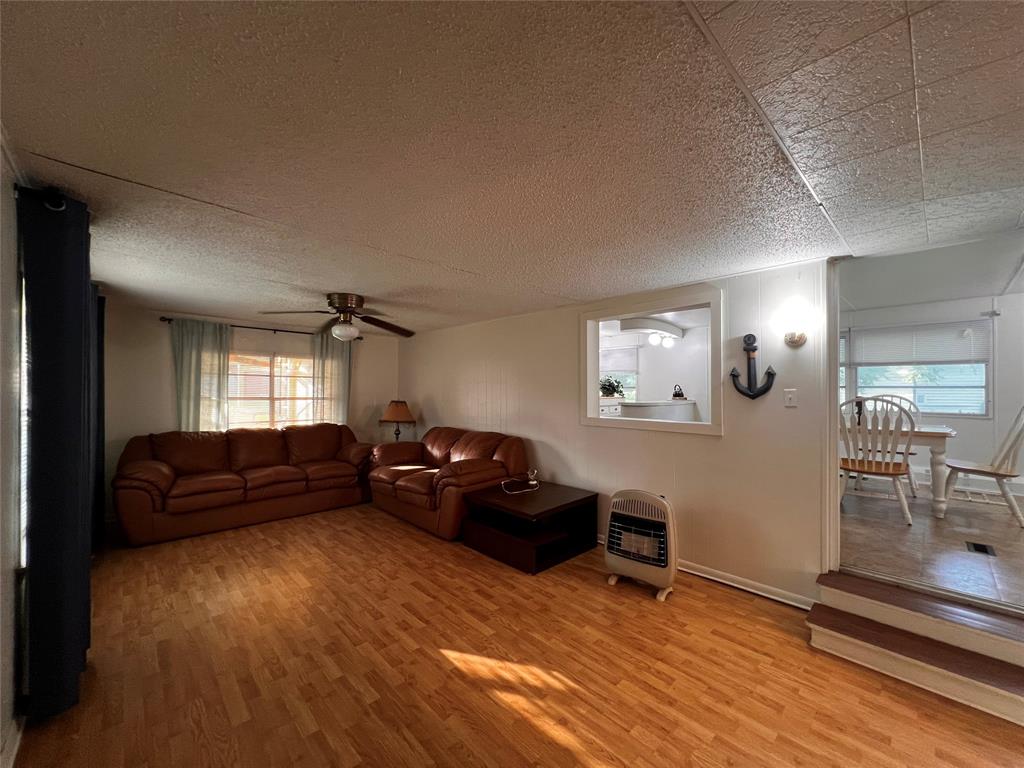 1036 Paradise Cove Road Pottsboro, TX 75076 - Photo 36 of 40 a living room with furniture and a wooden floor