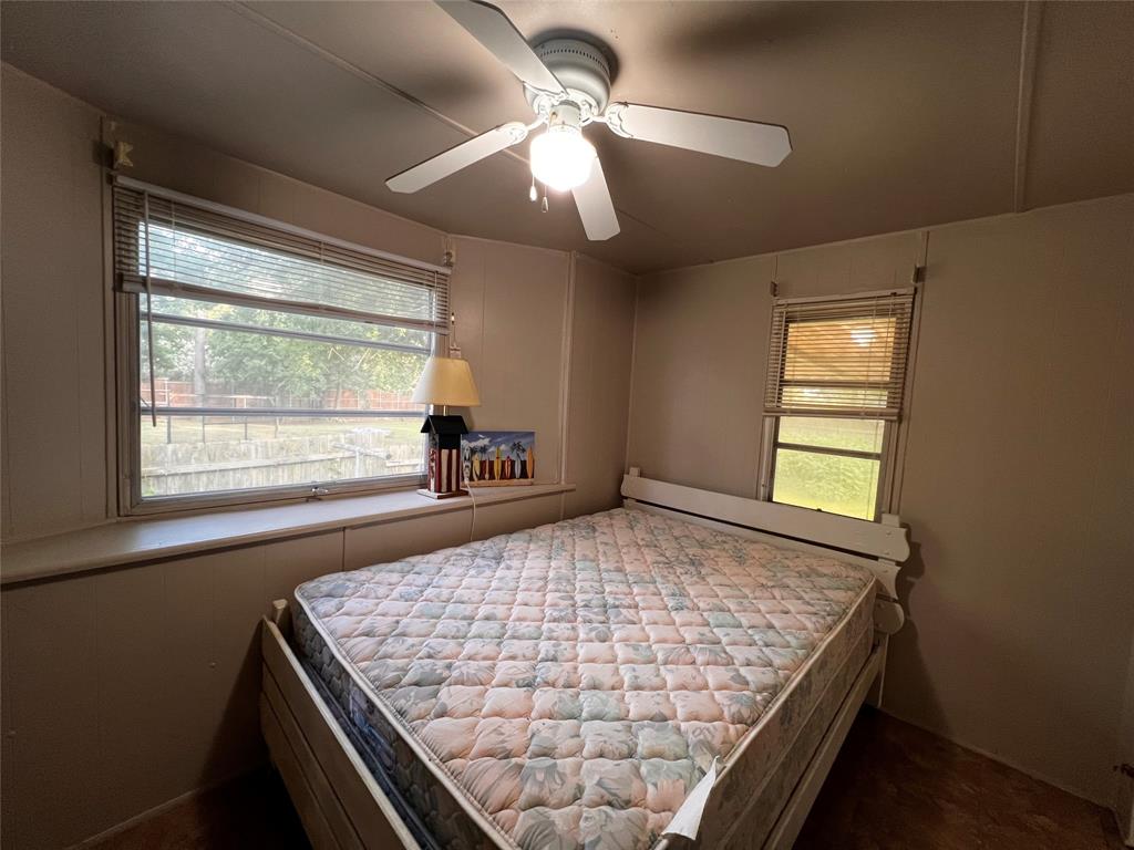 1036 Paradise Cove Road Pottsboro, TX 75076 - Photo 39 of 40 a bed sitting in a bedroom next to a window