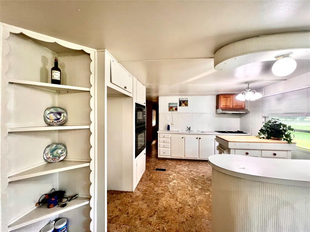 1036 Paradise Cove Road Pottsboro, TX 75076 - Photo 7 of 40 a kitchen with a refrigerator and window
