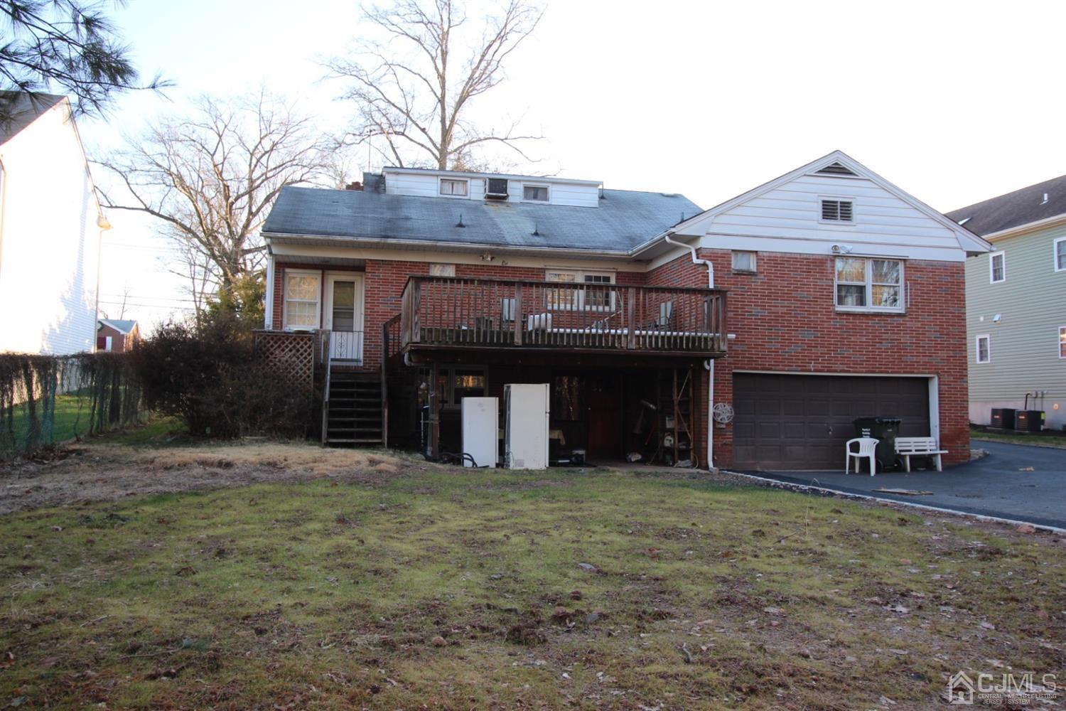 103 Jordan Road Colonia, NJ 07067 - Photo 3 of 4 a view of a house with a yard and garage