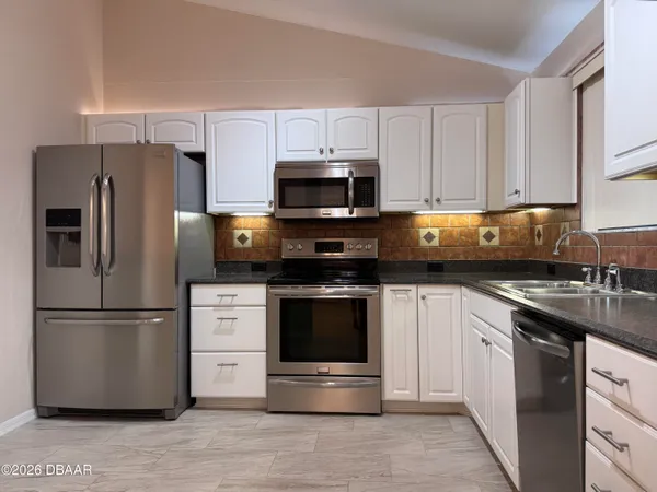 a view of a hallway with wooden floor and closet