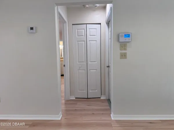 a view of a hallway with wooden floor