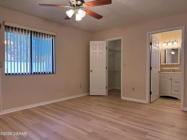 a bathroom with a granite countertop sink a toilet and a mirror