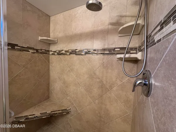 a view of an empty room with large windows