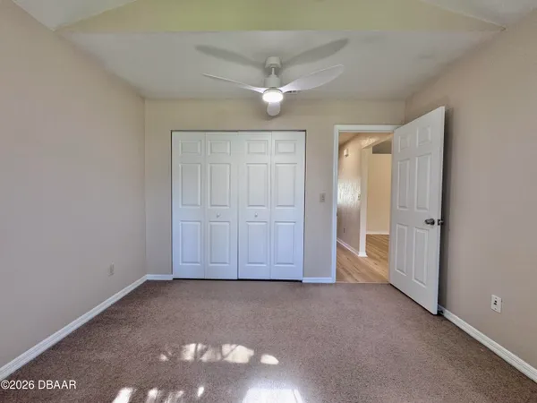 an empty room with closet area