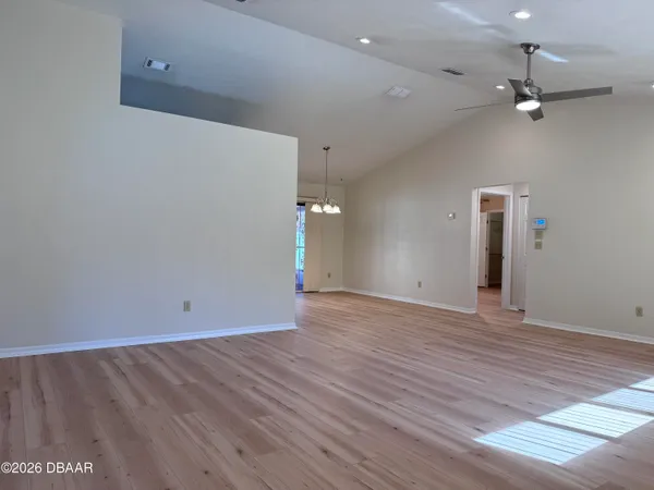 a view of a kitchen with a stove wooden cabinet and a refrigerator