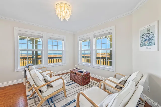 a workspace with furniture a chandelier and wooden floor