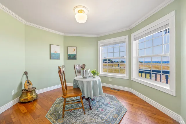 a workspace room with furniture windows and wooden floor