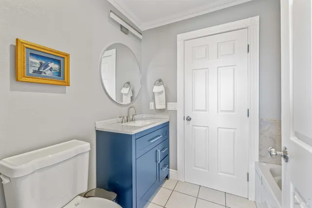 a bathroom with a toilet a sink and a mirror