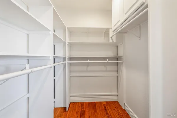 a view of walk in closet with empty racks