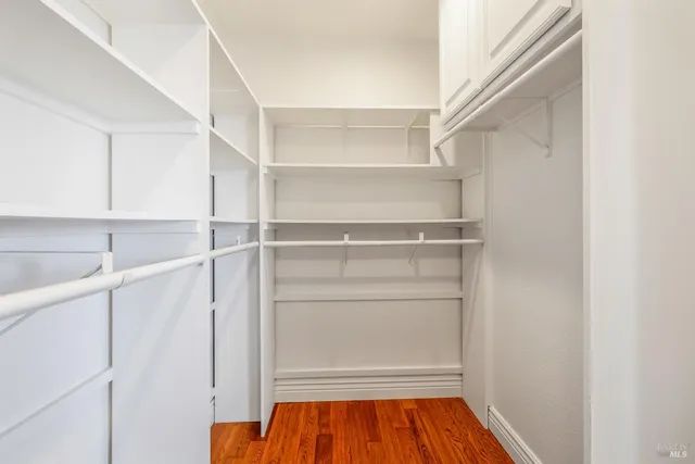 a view of walk in closet with empty racks