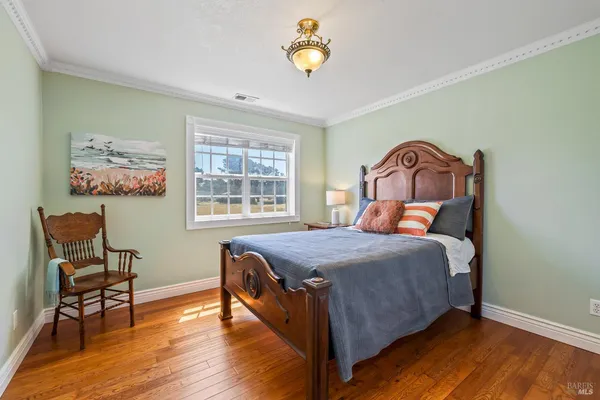 a bed sitting in a bedroom next to a window