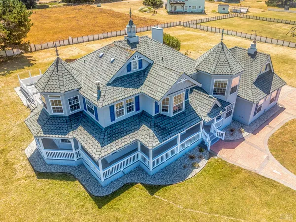 a view of a house with pool and chairs