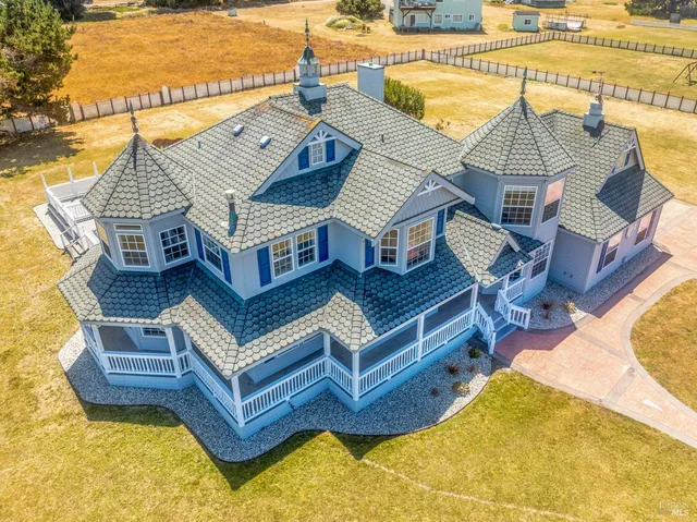 a view of a house with pool and chairs