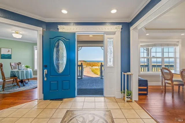 a view of a hallway with dining area and chandelier