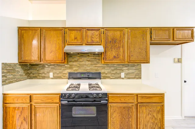 a kitchen with stainless steel appliances granite countertop a stove and a microwave
