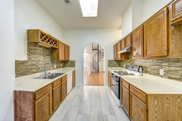 a kitchen with stainless steel appliances granite countertop a stove and a sink