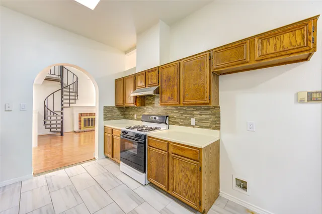 a kitchen with stainless steel appliances granite countertop a stove and a refrigerator