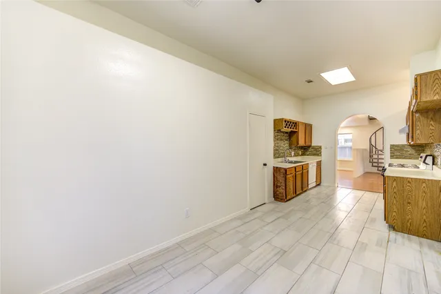 a kitchen with stainless steel appliances a refrigerator and a stove top oven