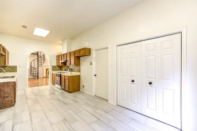 a kitchen with stainless steel appliances a refrigerator and a stove