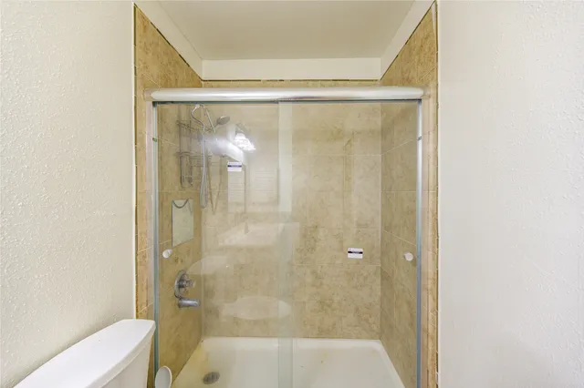 a bathroom with a glass shower door