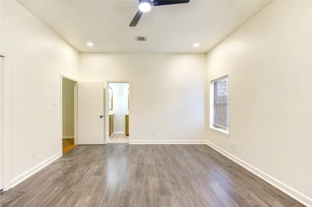 a view of wooden floor and windows in a room