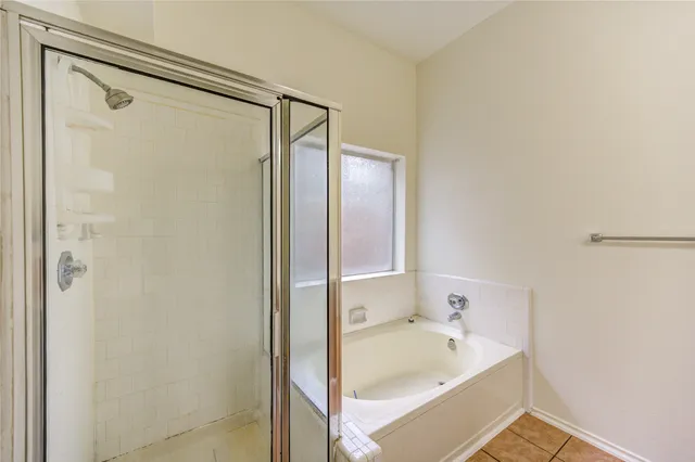 a bathroom with a bathtub and a shower