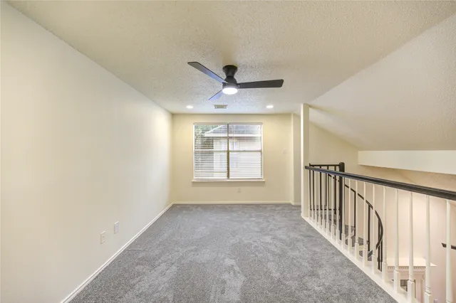a view of a livingroom with a ceiling fan and window