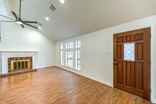 wooden floor chandelier and windows in a room