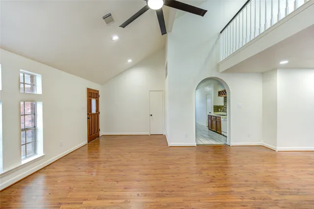 a view of empty room with wooden floor