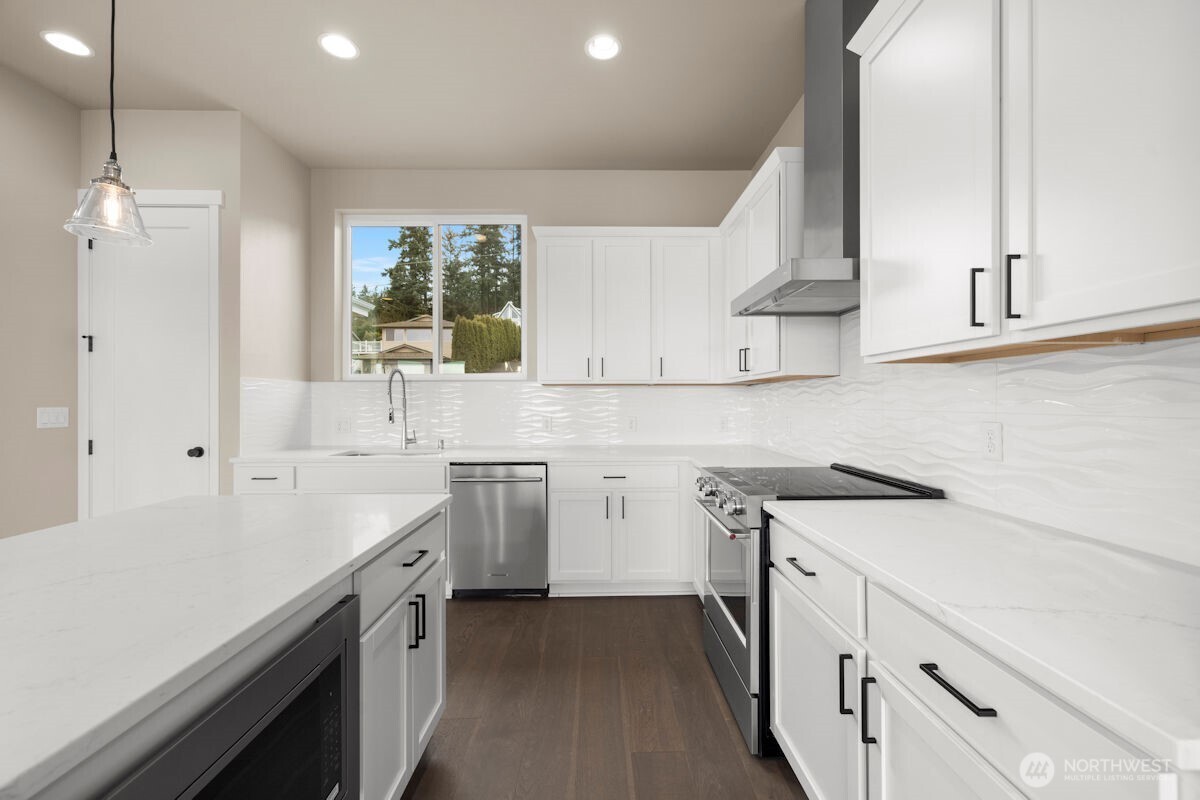 2216 Cleven Park Road Camano Island, WA 98282 - Photo 12 of 38 a kitchen with a sink stove and cabinets