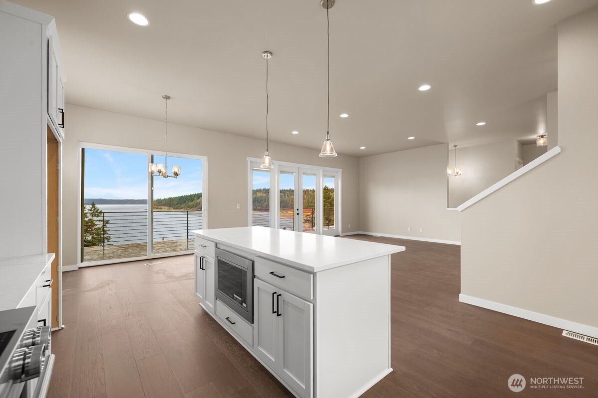 2216 Cleven Park Road Camano Island, WA 98282 - Photo 15 of 38 a kitchen with stainless steel appliances granite countertop a sink a stove and a large window