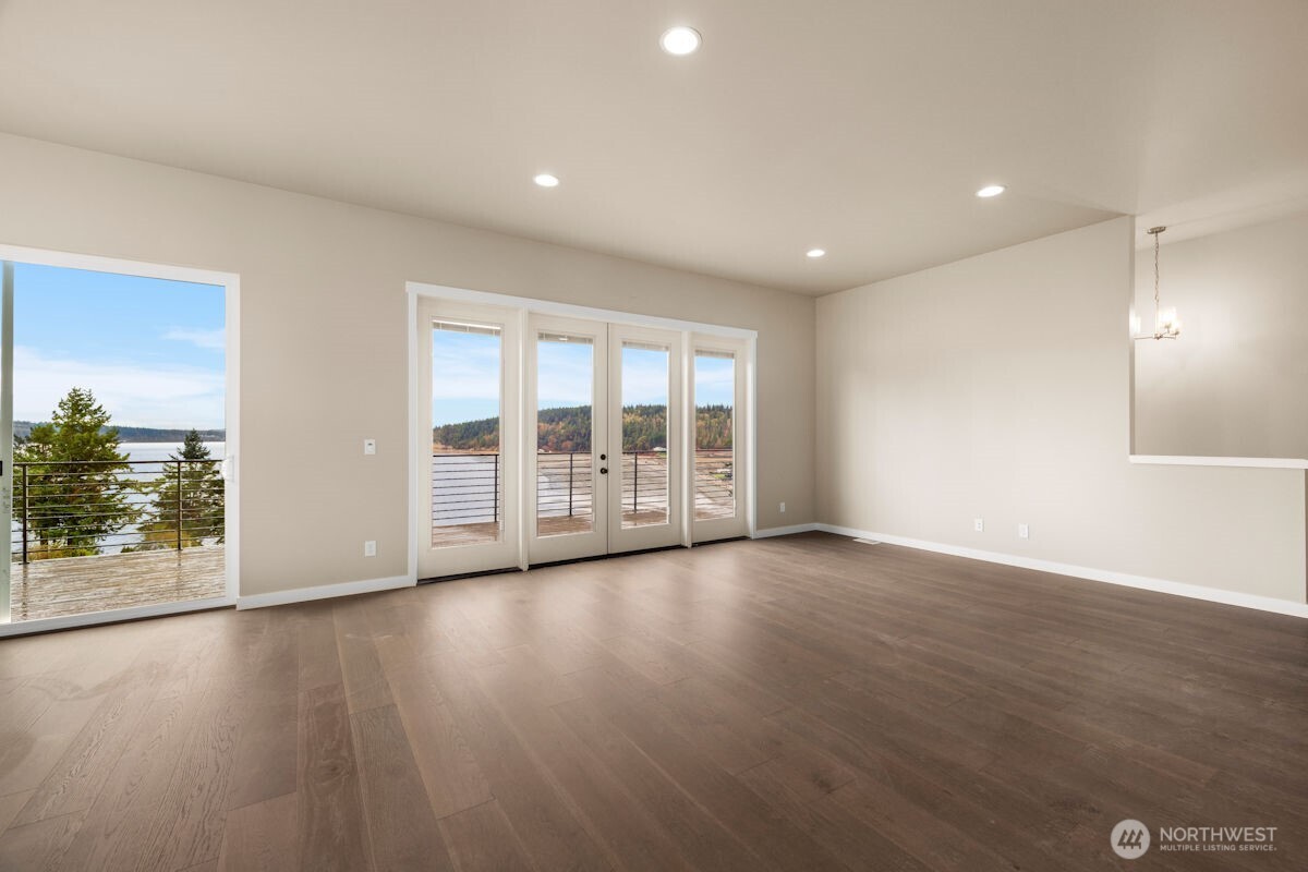 2216 Cleven Park Road Camano Island, WA 98282 - Photo 18 of 38 a view of an empty room with wooden floor and a window