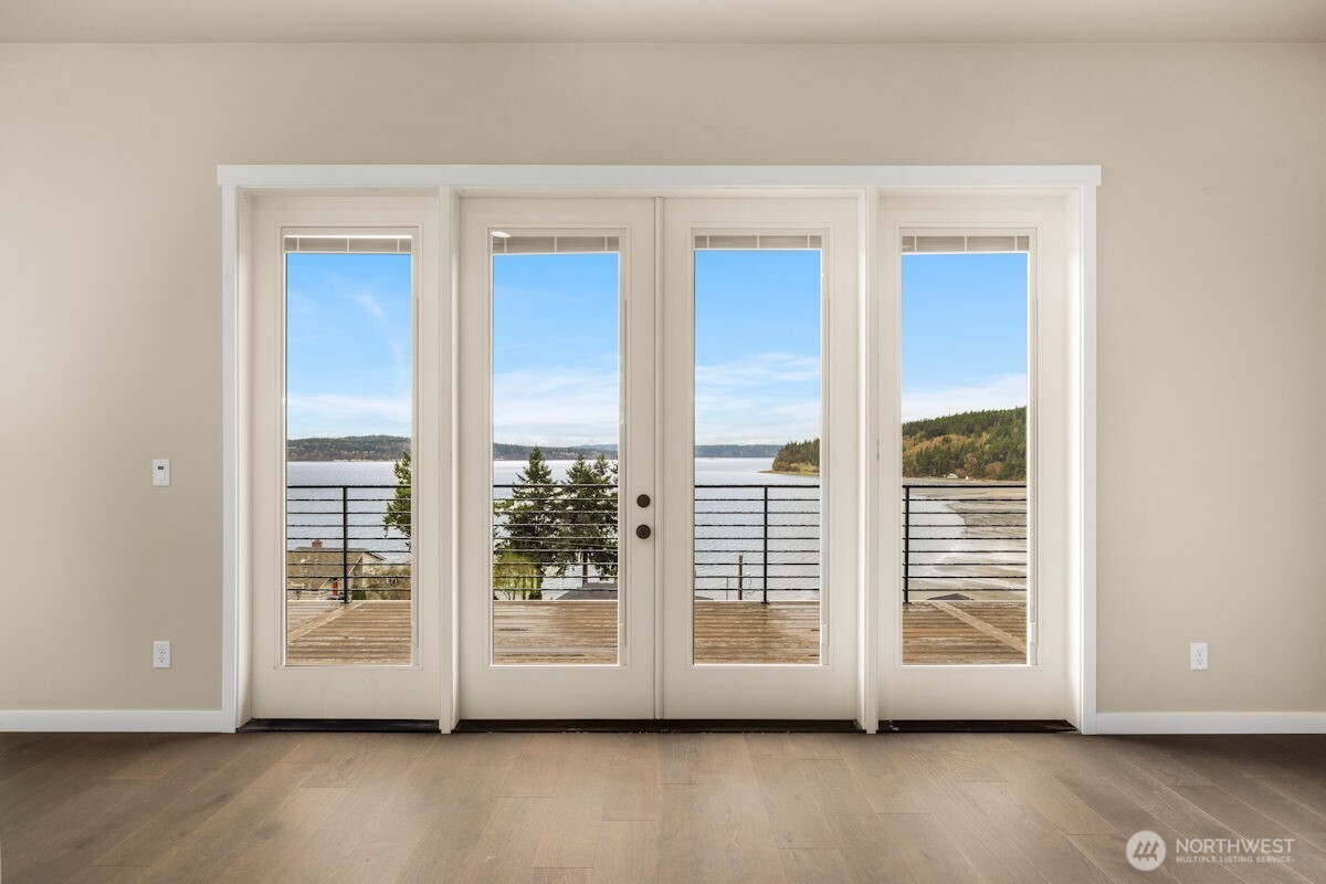 2216 Cleven Park Road Camano Island, WA 98282 - Photo 19 of 38 a view of a room with wooden floor and windows