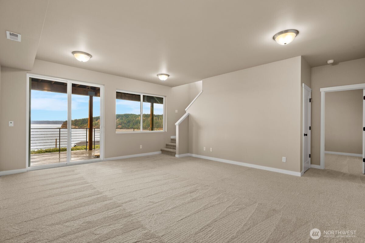 2216 Cleven Park Road Camano Island, WA 98282 - Photo 29 of 38 an empty room with wooden floor and windows