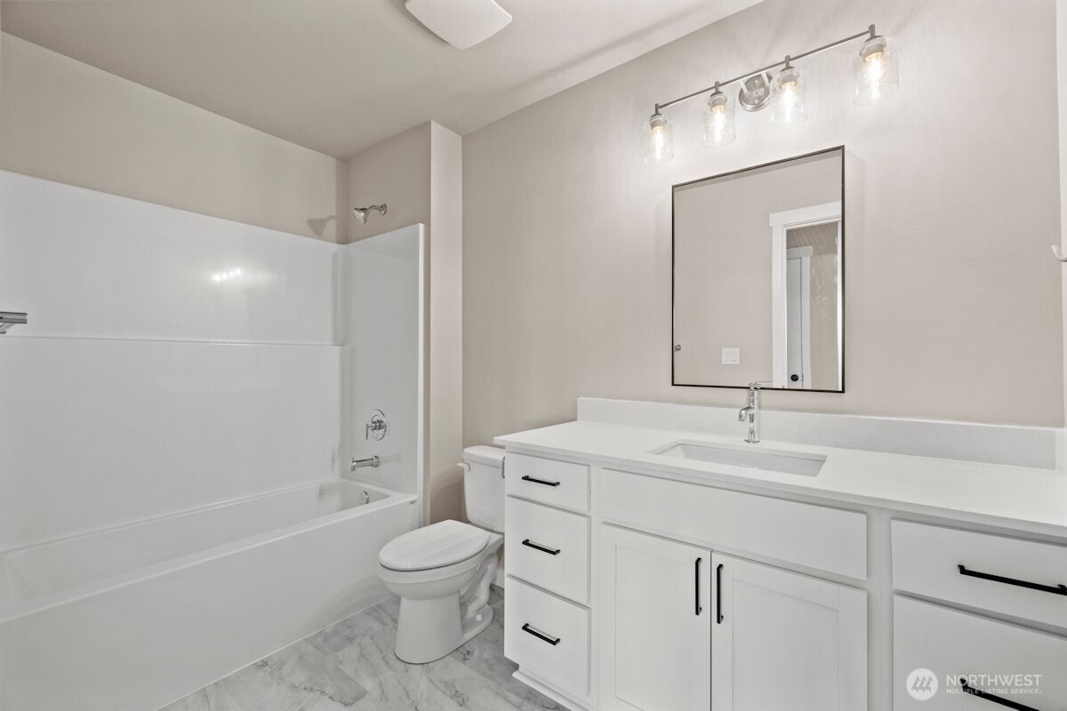 2216 Cleven Park Road Camano Island, WA 98282 - Photo 33 of 38 a bathroom with a toilet a sink a mirror a bathtub and vanity