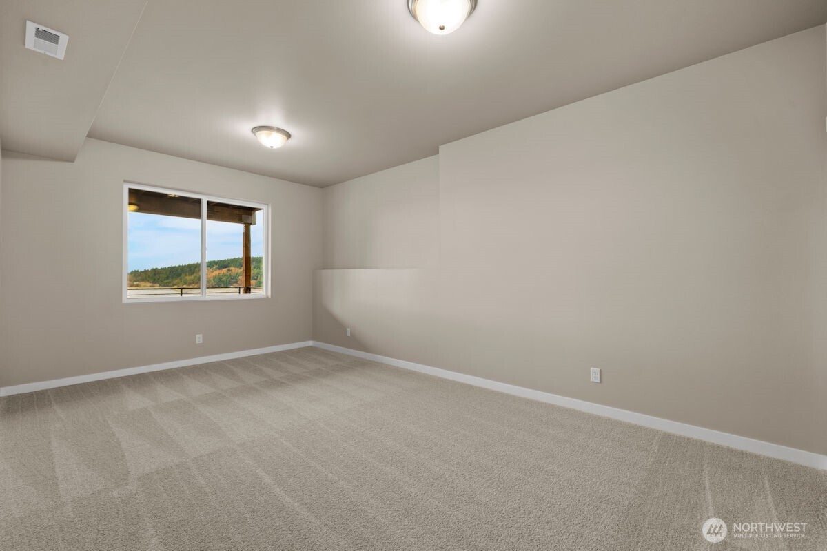 2216 Cleven Park Road Camano Island, WA 98282 - Photo 34 of 38 an empty room with windows and mirror