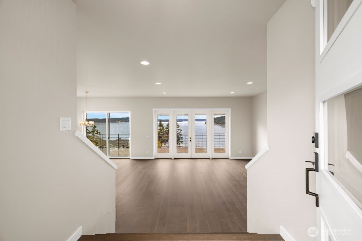 2216 Cleven Park Road Camano Island, WA 98282 - Photo 6 of 38 a view of an empty room with wooden floor and a window