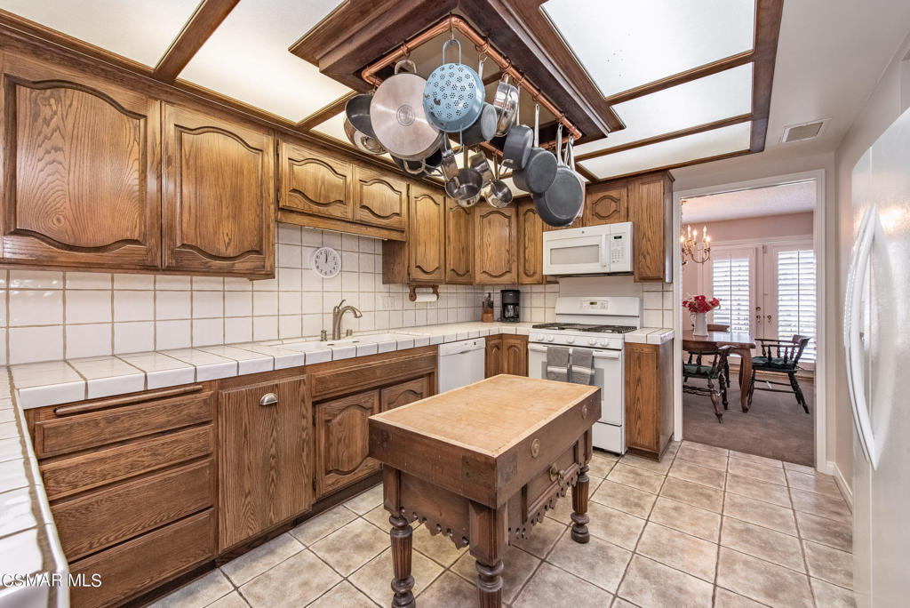 2025 Napoli Drive Oxnard, CA 93035 - Photo 11 of 47 a kitchen with a sink a stove and cabinets