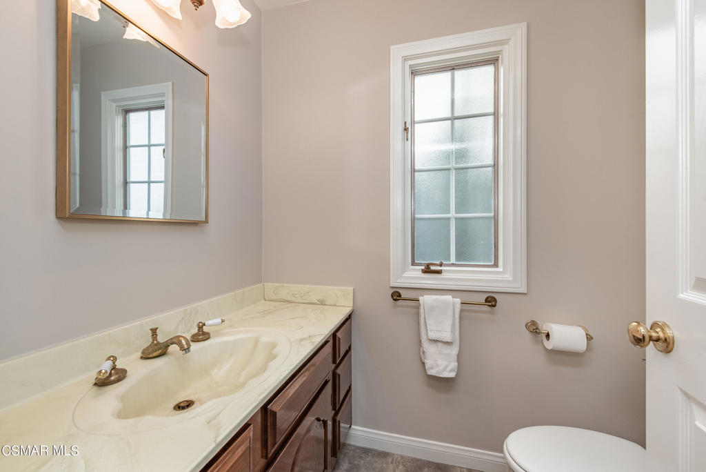 2025 Napoli Drive Oxnard, CA 93035 - Photo 14 of 47 a bathroom with a sink toilet a mirror and window