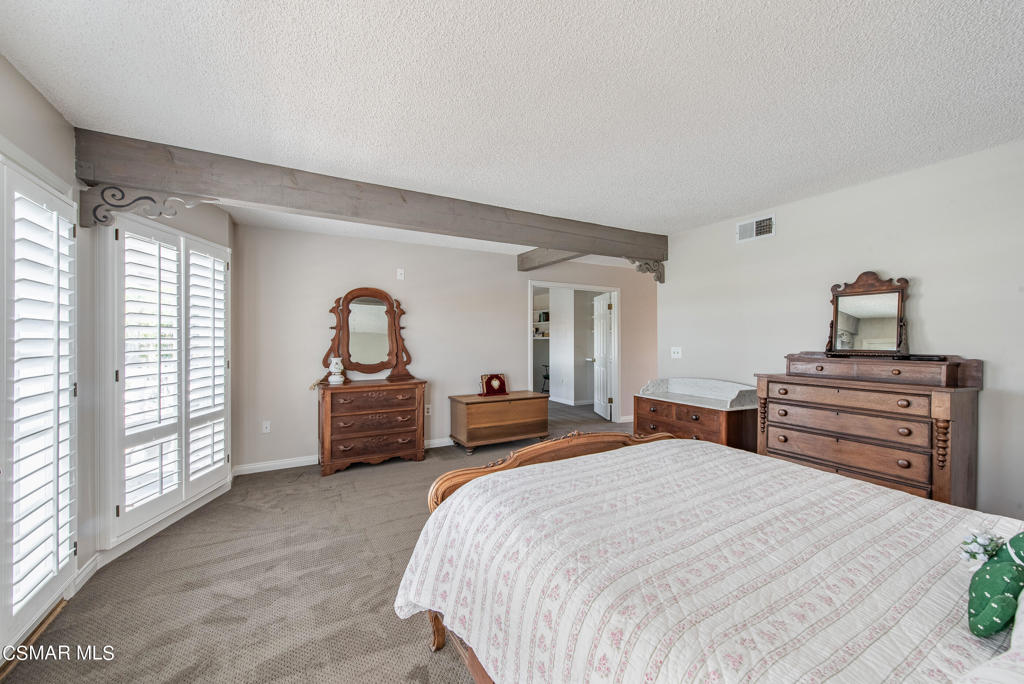 2025 Napoli Drive Oxnard, CA 93035 - Photo 17 of 47 a bedroom with a bed and a dresser next to a window
