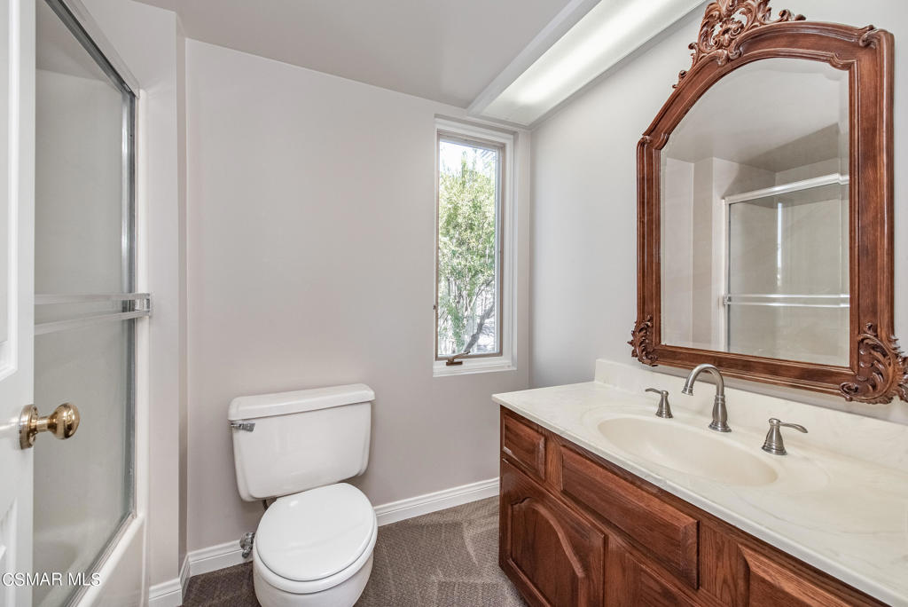 2025 Napoli Drive Oxnard, CA 93035 - Photo 25 of 47 a bathroom with a toilet sink and mirror