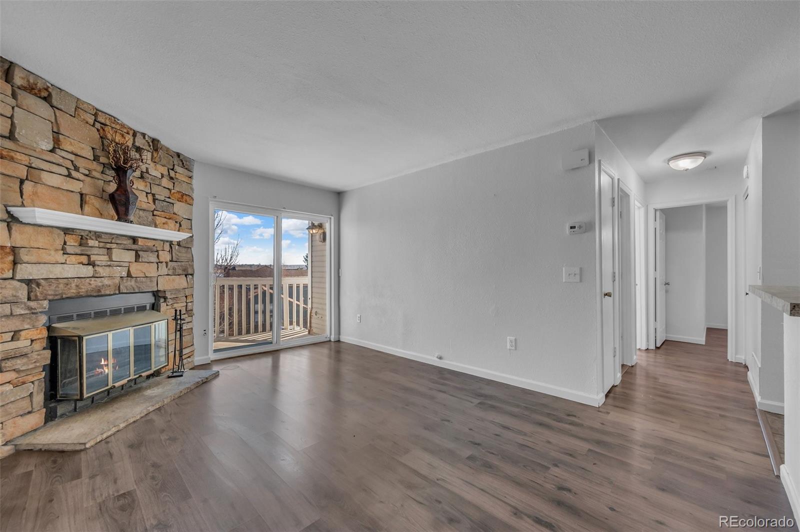wooden floor in an empty room with a fireplace