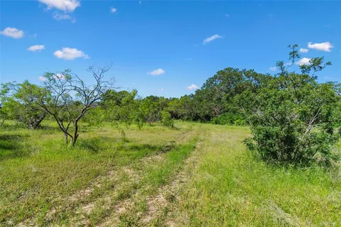 a backyard of a house with a yard and outdoor seating