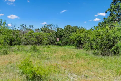 a view of a lake with a yard