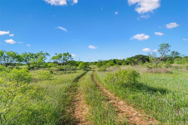 a view of a lake with a yard