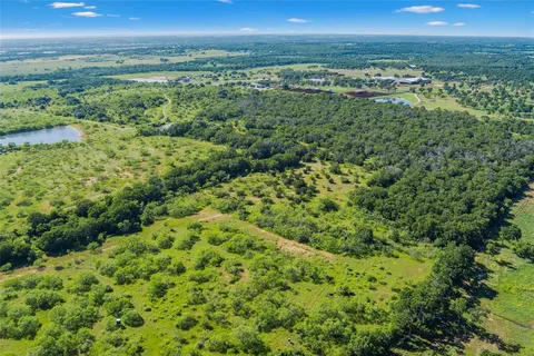 a view of a green field with an ocean view