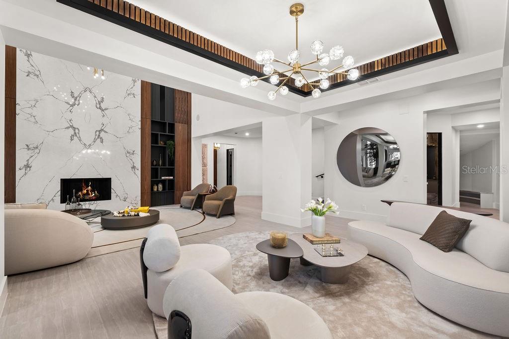 9725 Chestnut Ridge Drive Windermere, FL 34786 - Photo 12 of 55 a living room with furniture a fireplace and a chandelier