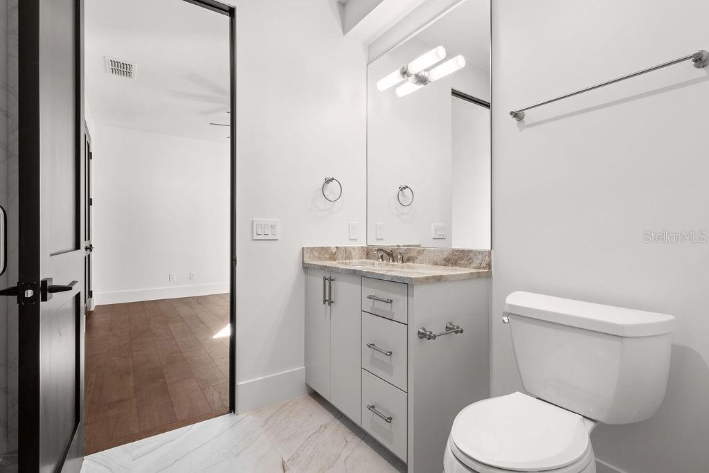 9725 Chestnut Ridge Drive Windermere, FL 34786 - Photo 30 of 55 a bathroom with a granite countertop sink toilet and shower