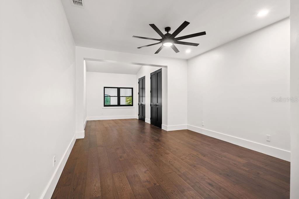 9725 Chestnut Ridge Drive Windermere, FL 34786 - Photo 39 of 61 a view of a big room with wooden floor and windows